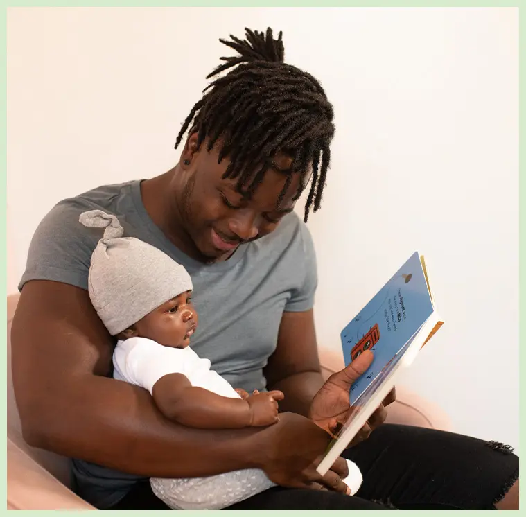 A man reading to his baby